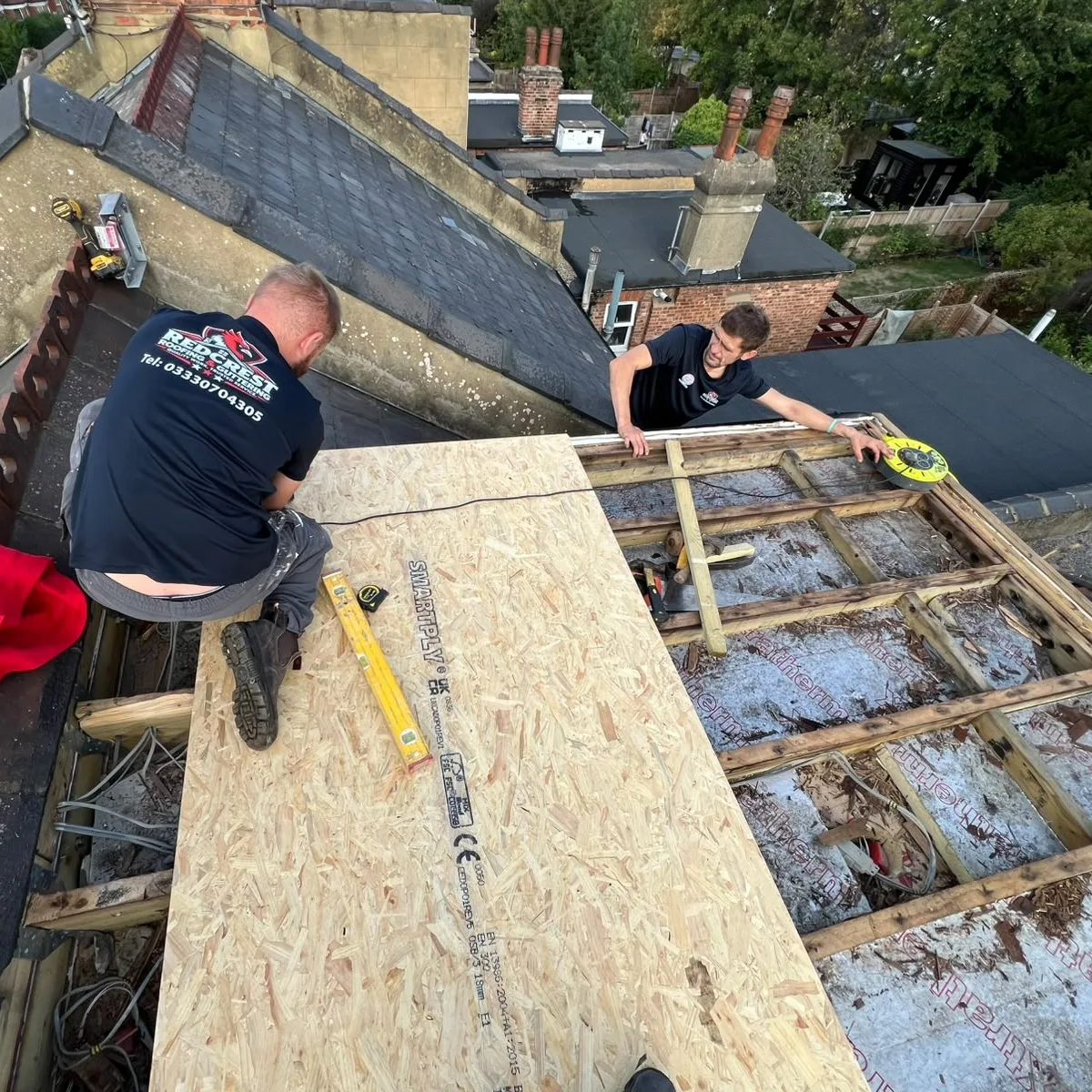 Roofers boarding a flat roof