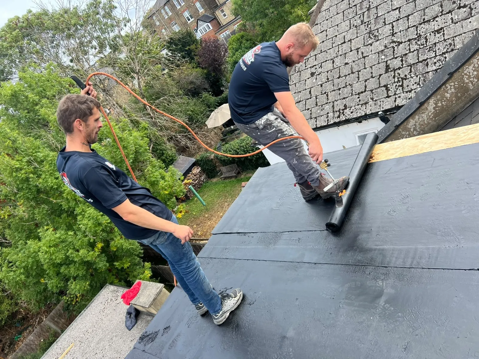 A Redcrest roofer carrying out lead and tile work on a Berkshire roof