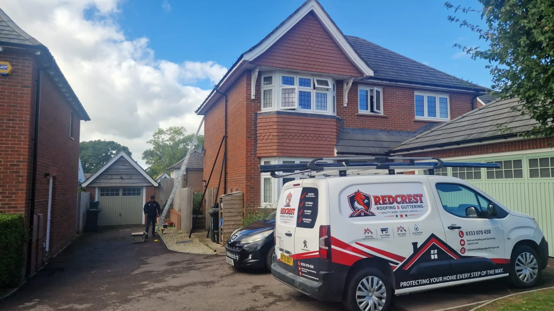 The sign-written Redcrest Roofing & Guttering van on a driveway in Berkshire